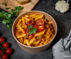Penne à la sauce bolognaise mijotée, tomates cerises fraîches et persil